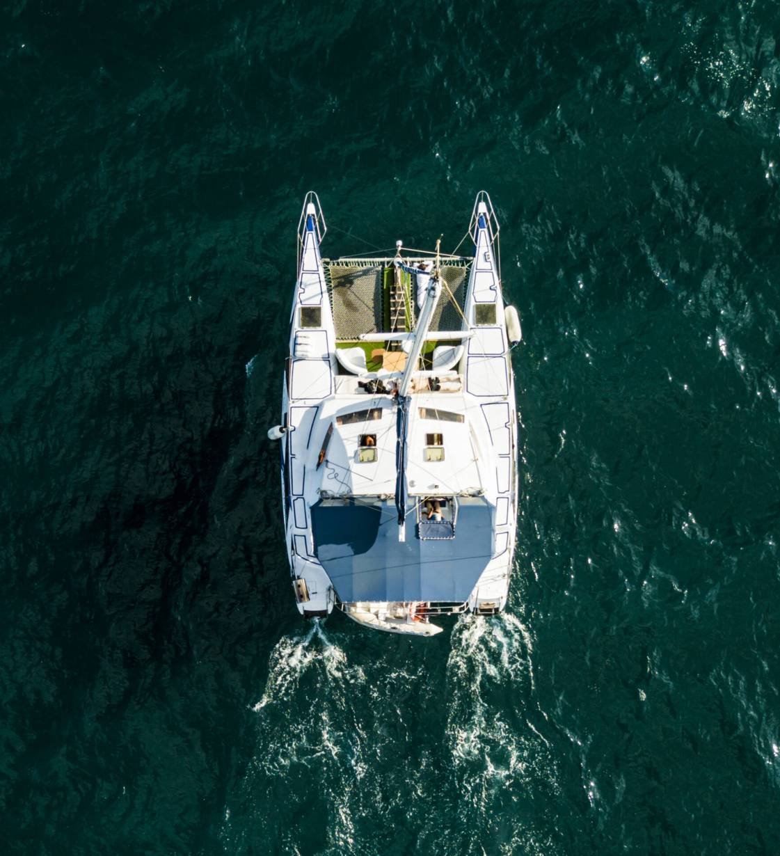 aerial top view from above of large sailing catamaran in the open sea isolated